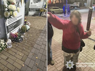 Жінка пошкодила лампадки та порозкидала квіти біля портретів загиблих Героїв